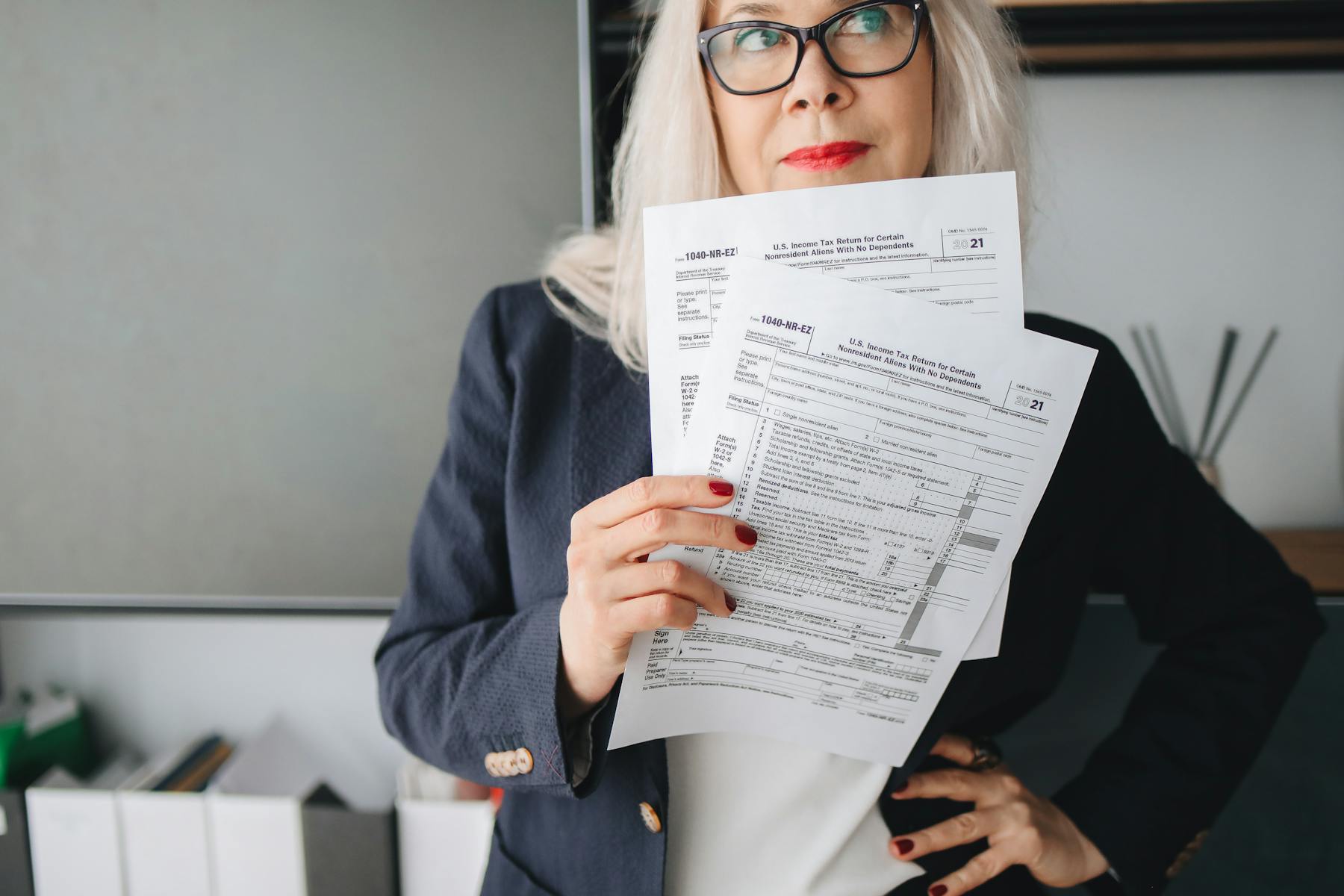 Tax advisor and business owner reviewing tax documents together at a desk.