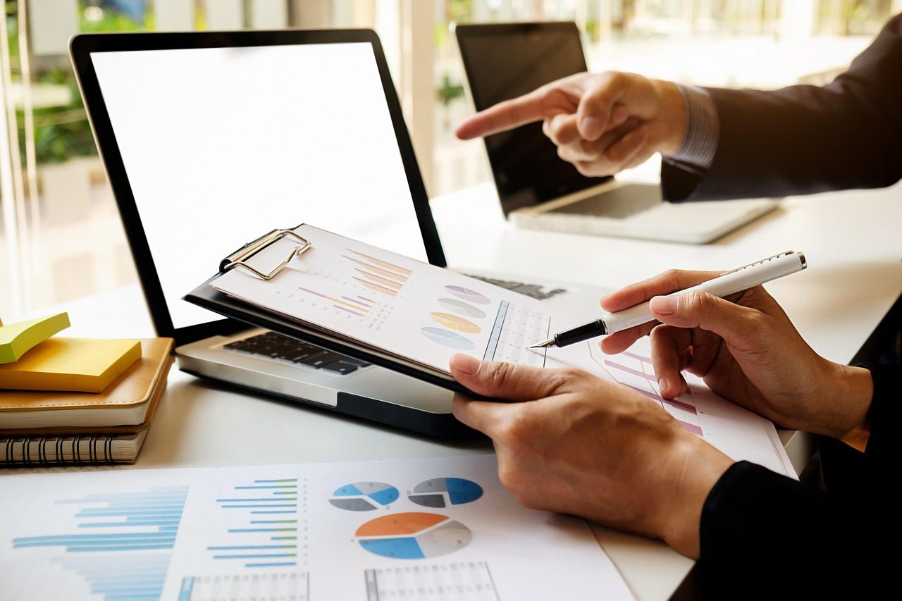 Professionals reviewing financial reports during a business finance meeting